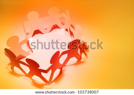 Group of people holding hands in a circle. Copy space