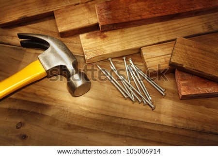 Hammer, nails and pieces of wood