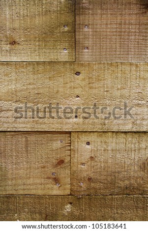 Closeup of nails in planks of pine wood. Vertical
