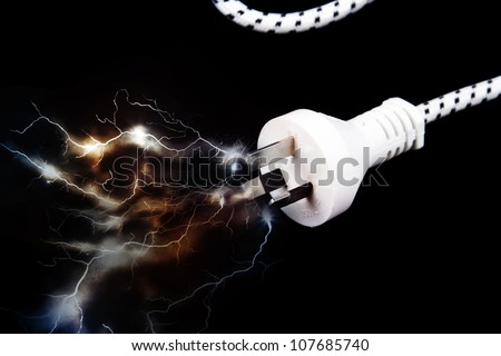 Electric plug on black with sparks