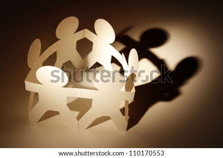 Team of paper doll people in a circle
