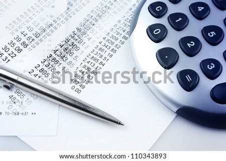 Closeup of financial figures, pen and calculator