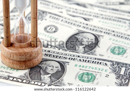 Sand passing through timer on American banknotes
