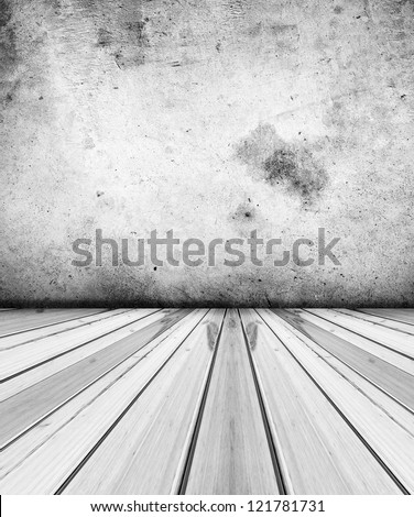 Grey floorboards and concrete wall
