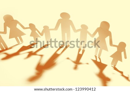 Family holding hands, casting shadows