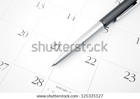 Pen on calendar page closeup
