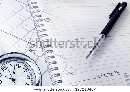 Pen, clock, diary, calendar page and keyboard