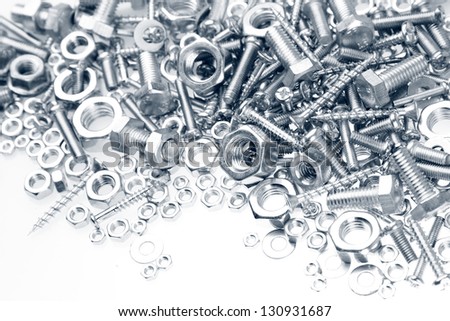 Chrome nuts and bolts closeup on plain background