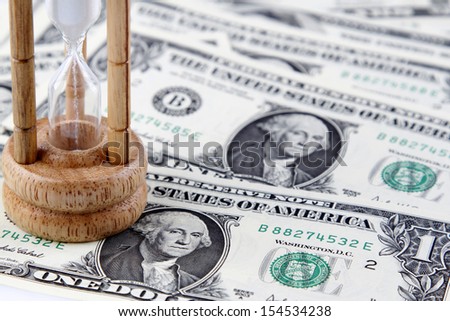 Sand passing through timer on banknotes
