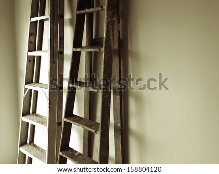 Ladders leaning up against wall