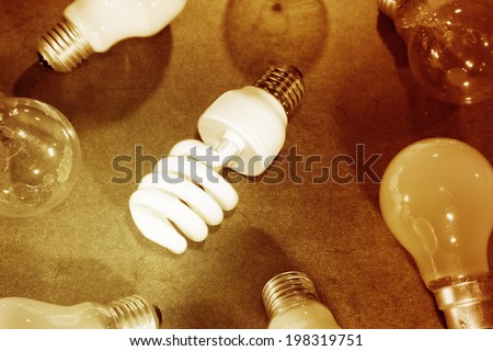 Power saving light bulb in group of assorted bulbs