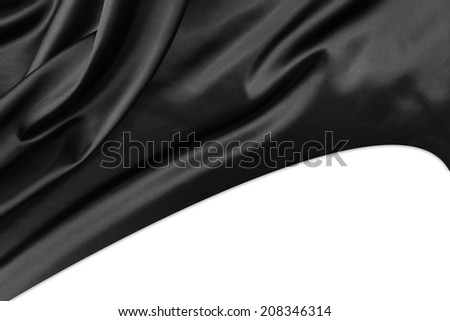 Closeup of rippled black silk fabric on plain background