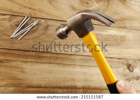 A nail being hammered into wood