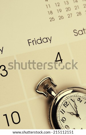 Closeup of watch on calendar