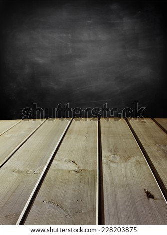 Wooden floorboards and blackboard wall