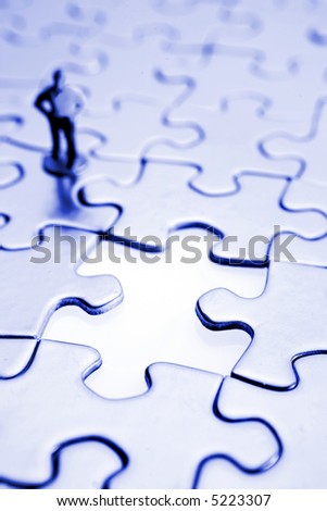 Figure looking at gap in jigsaw puzzle