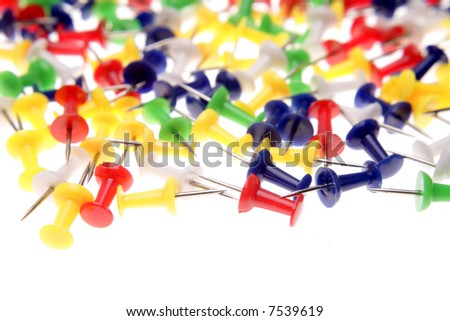 Colorful push-pins over white background