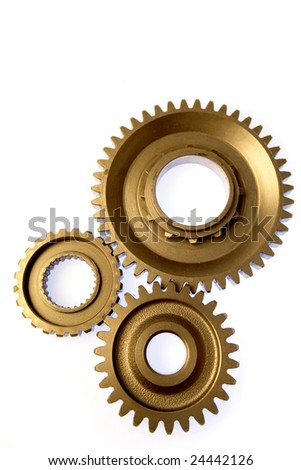 Three gears meshing together over white