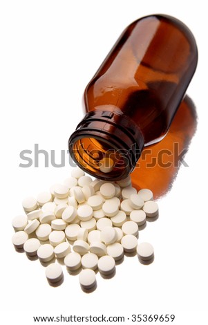 Pills spilling from bottle