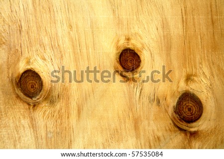 Close-up of knots in timber panel.