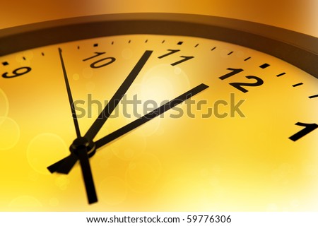 Hands of clock pointing to midday