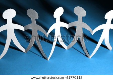 Group of paper doll people holding hands