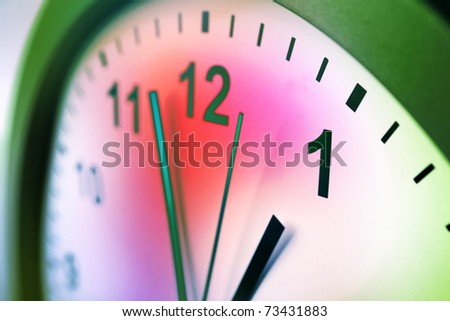 Hands of clock pointing to midday