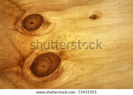 Two large knots in wood paneling
