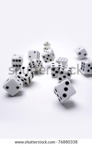 Dice rolling on plain background
