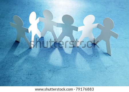 Group of paper chain people holding hands together. Teamwork concept