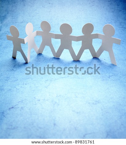 Line of paper doll people holding hands