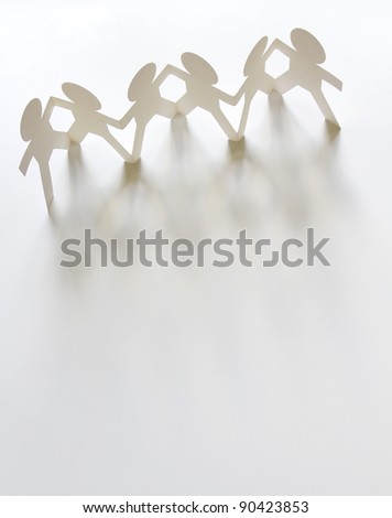 Group of paper chain people holding hands