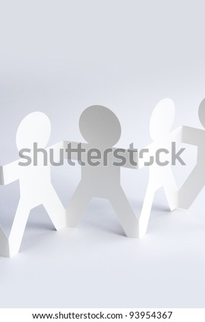 Paper doll people holding hands. Copy space