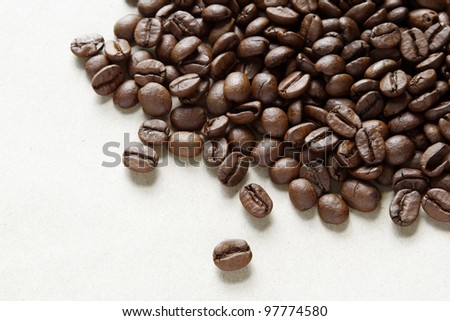 Closeup of coffee beans on plain background