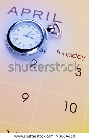 Pocket watch on calendar page