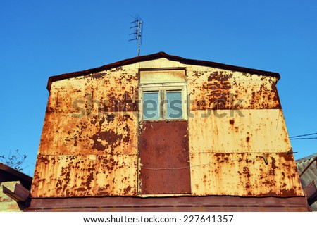 old rusty metal house with window