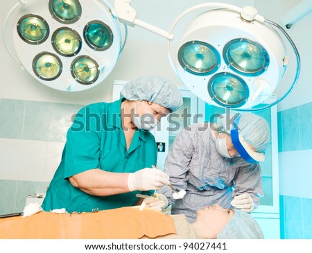 Serious medical operation in hospital by plastic surgeon