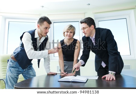 Business team in discussion working together in board room