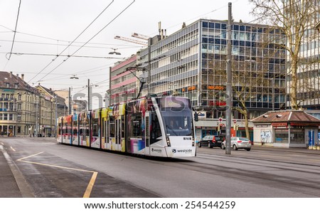 BERN, SWITZERLAND - FEBRUARY 15: Siemens Combino tram on Bubenbergplatz in Bern on February 15, 2015. There are 36 trams of this class in Bern