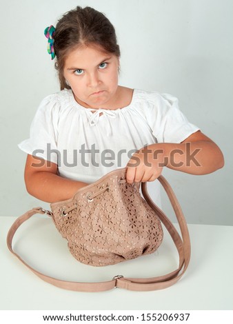 Little girl, caucasian, european, brown hair, blue eyes, looking in her hand-bag, angry, wondering