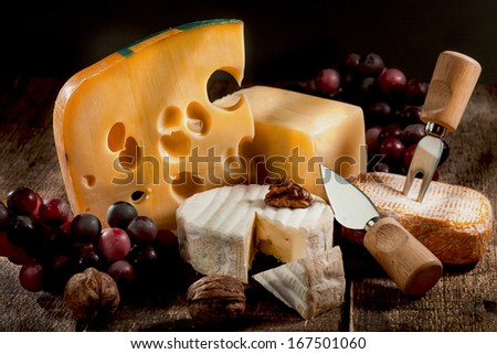 Various Types Of Cheese With Grapes And Nuts