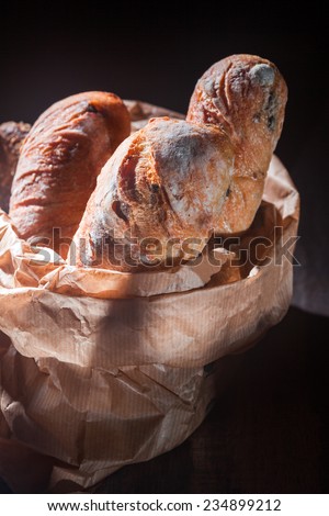 three loaves of bread in a paper bag