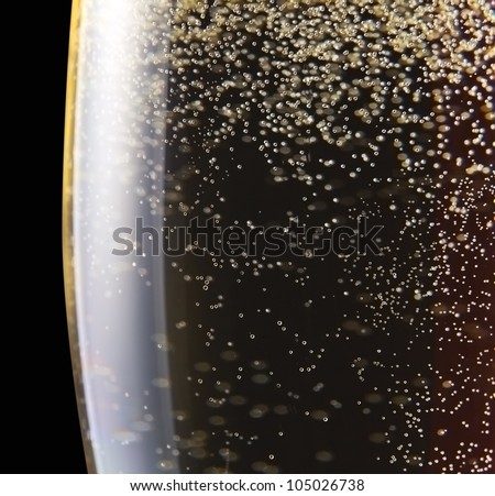 champagne in wineglass on a black background.Saved clipping path.