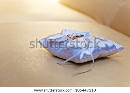 gold rings on a white silk pillow