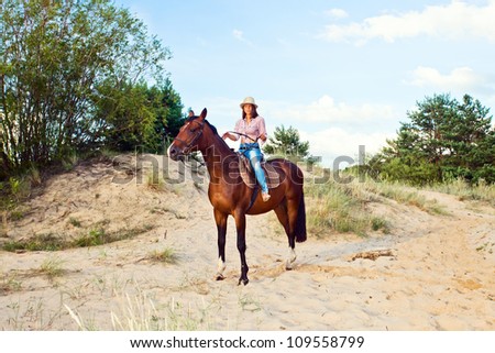 young beautiful girl on a  horse in forest