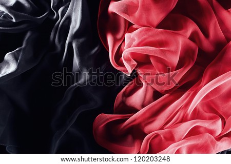red silk  scarf on a  black textile
