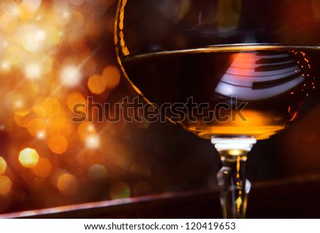 brandy for the maestro, snifter with brandy on a piano.