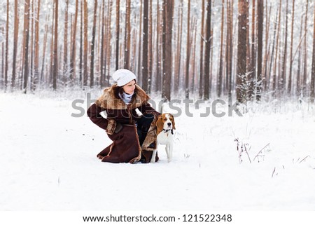 The woman on winter walk with a dog