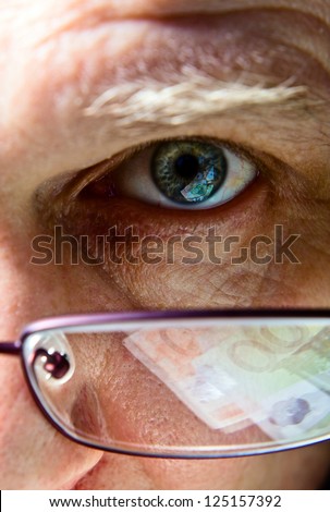 Eye of the businessman, natural reflexion in eyes and glasses