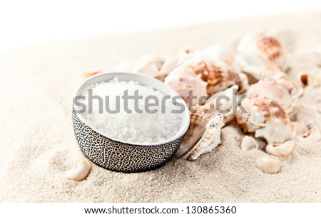 Sea salt and cockleshells on sea sand,white background